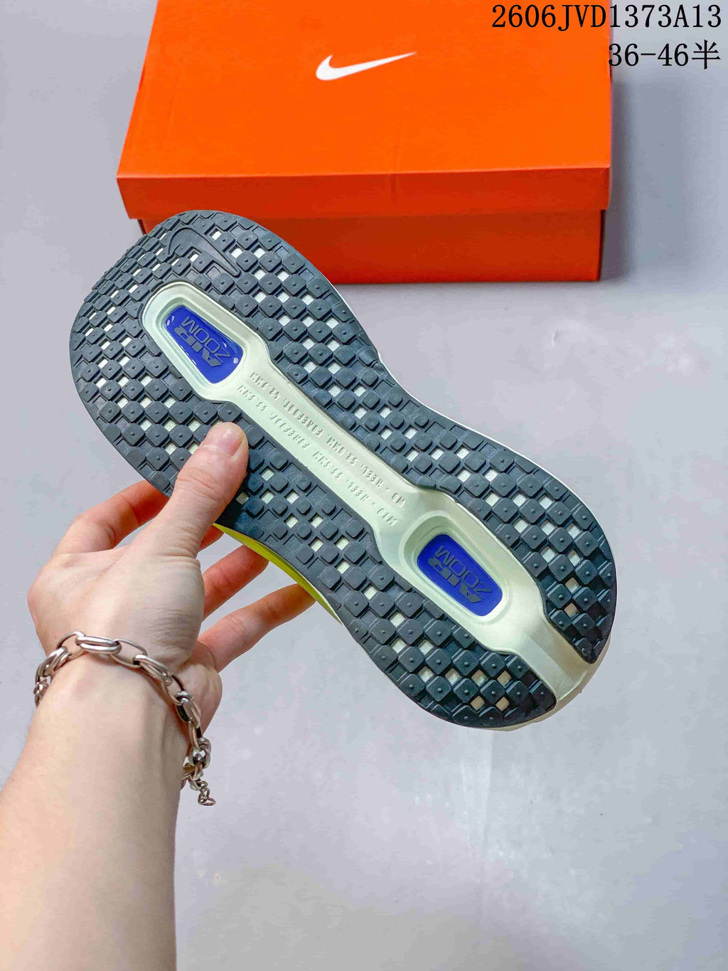 Underside of a Nike Vomero Premium shoe showing the dark patterned outsole