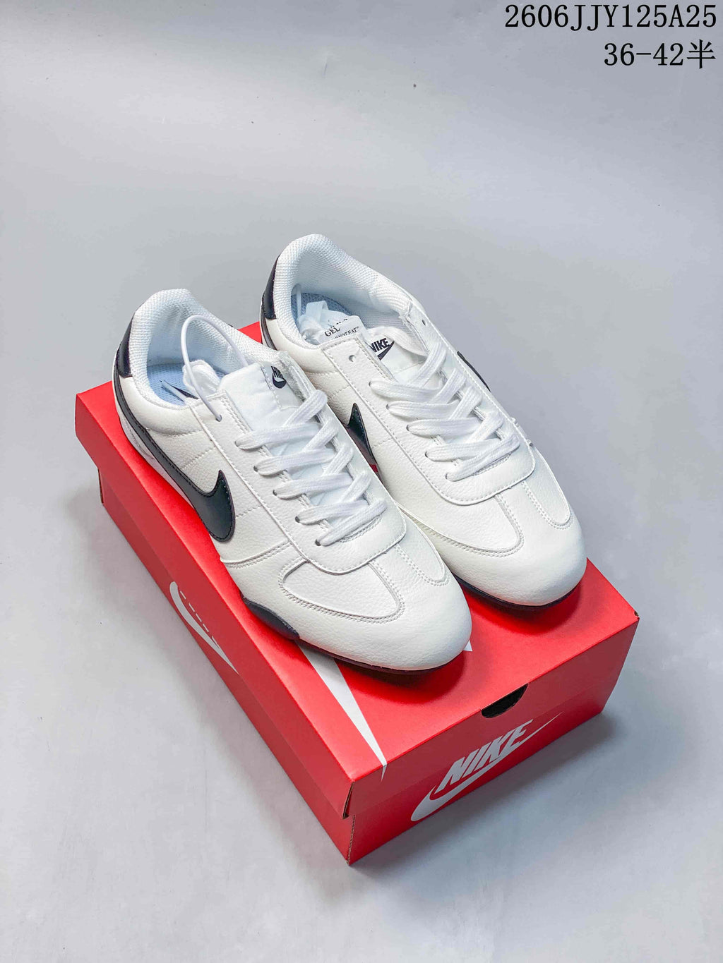 White low-profile Nike Sprint Sister sneakers with black accents on a red shoe box
