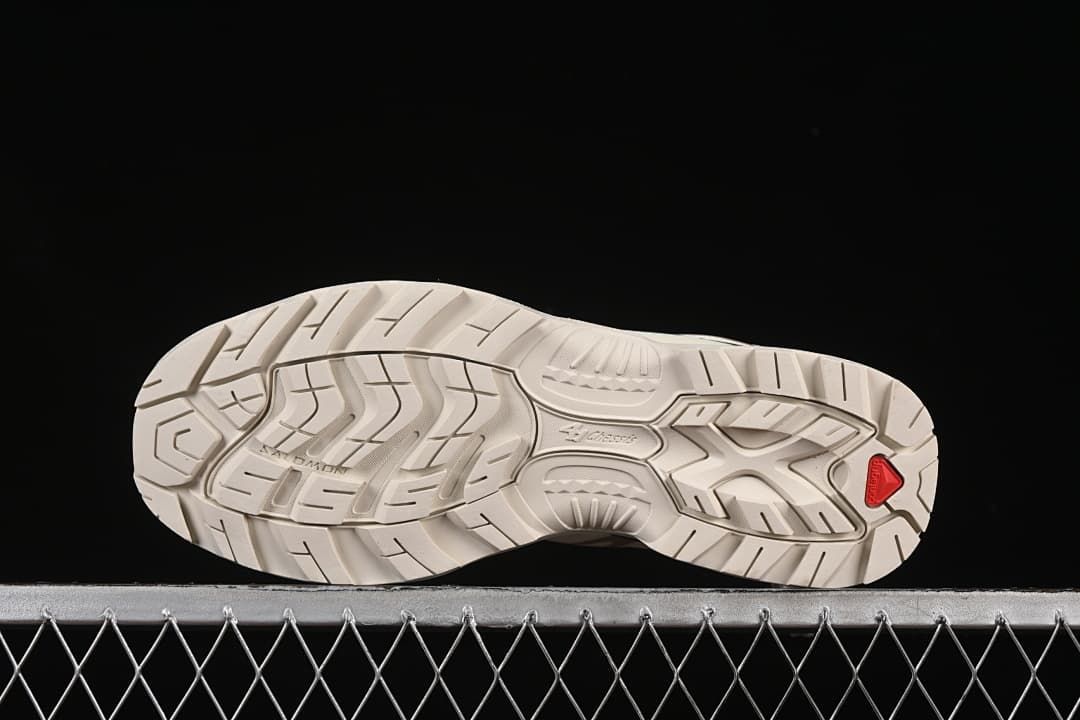 Underside view showing the tread pattern and red heel insert.