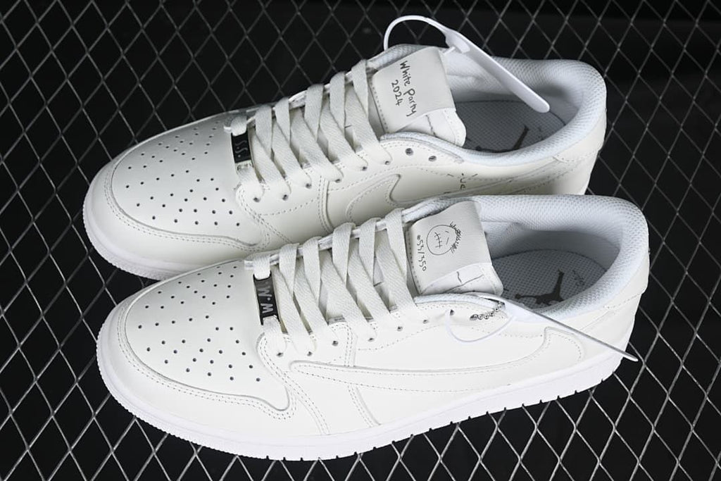 Top view of a pair of white low-top sneakers with custom-style tongue graphics.