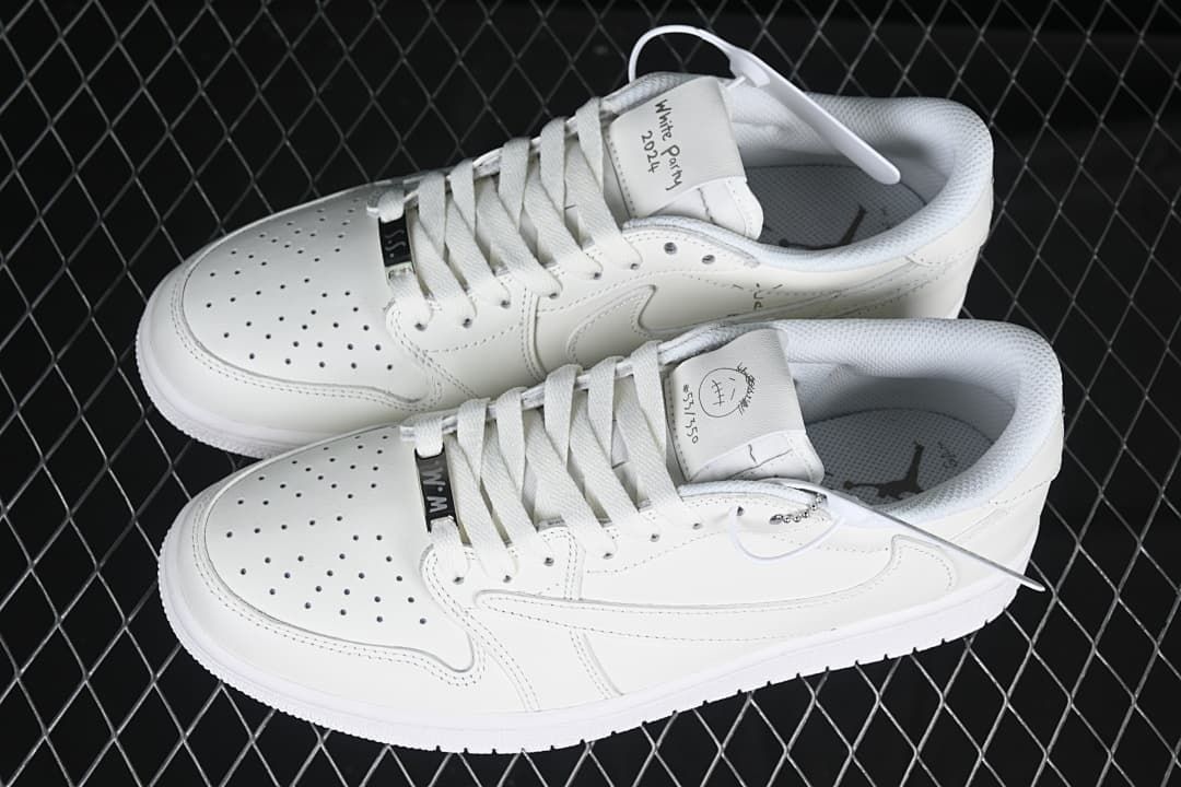 Top view of a pair of white low-top sneakers with custom-style tongue graphics.