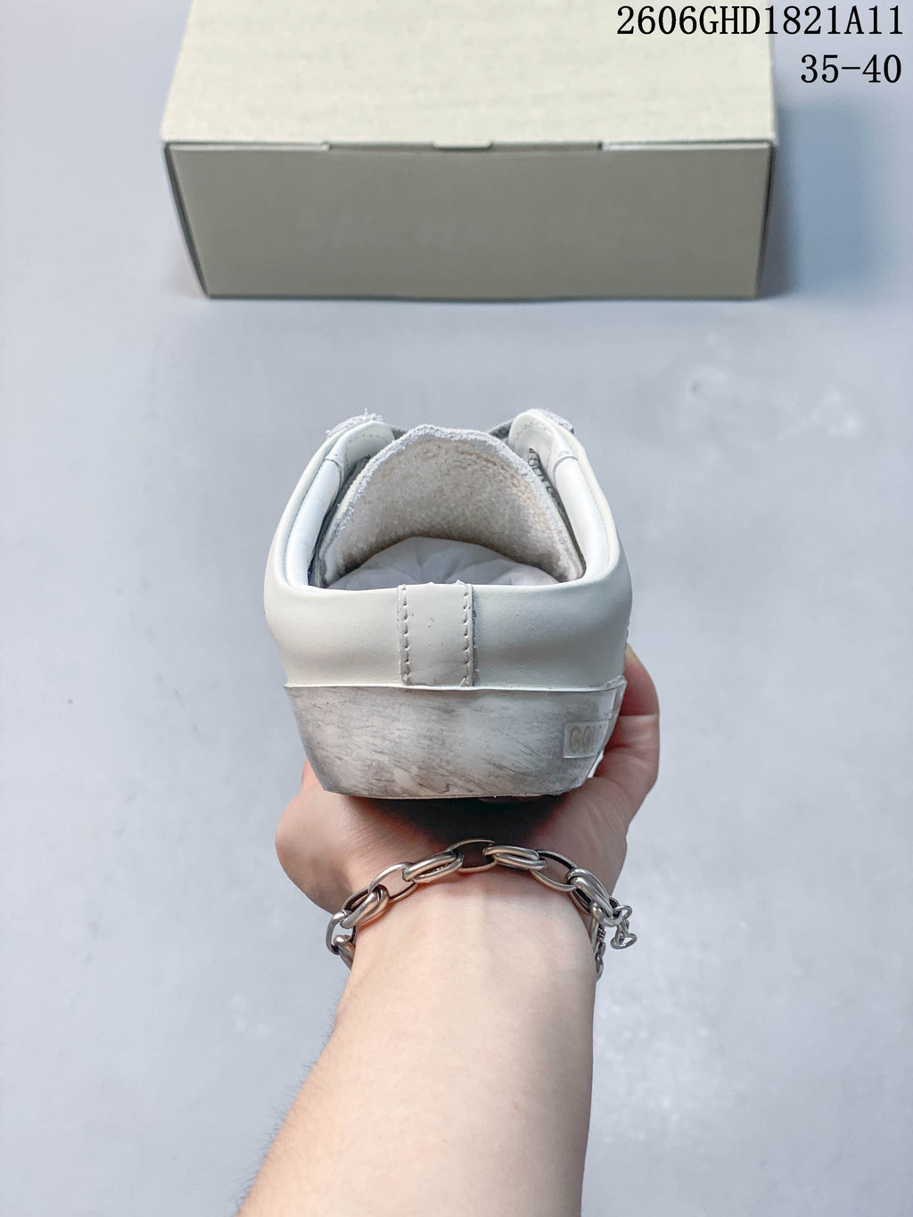 Rear view of the sneaker showing the heel and distressed-looking sole.