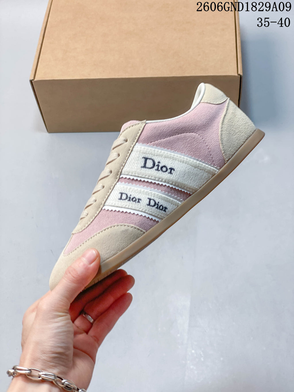 Side view showing pink and beige panels and branded side bands