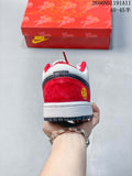 Rear view of the white and red low-top sneaker, showing a dark heel overlay, red heel panel, and decorative emblem.