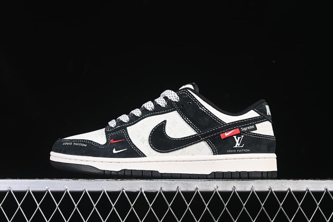 Side view of black and white low-top sneakers with patterned panels and red accents
