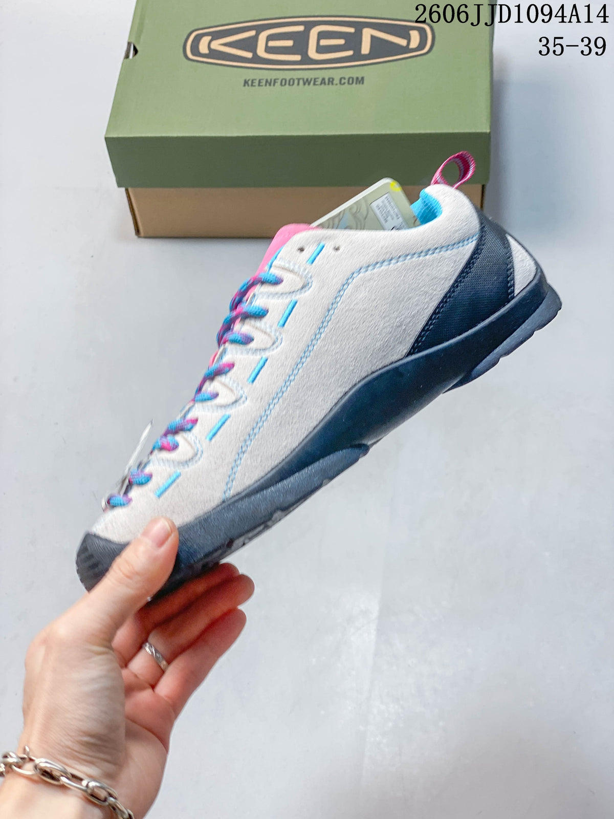 Side view of a light gray KEEN Jasper sneaker with a dark sole and colorful accents
