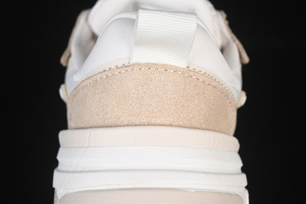 Rear view showing the beige heel panel and pull tab