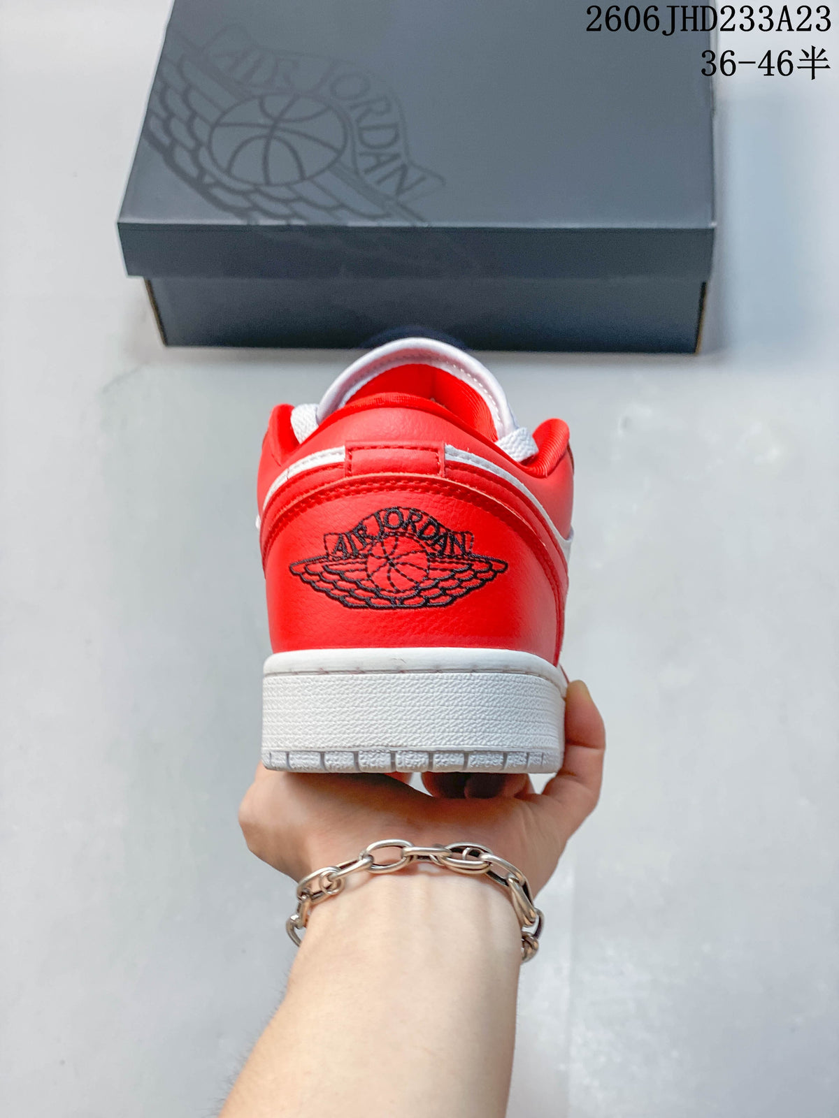 Rear view of a red low-top sneaker with a white midsole