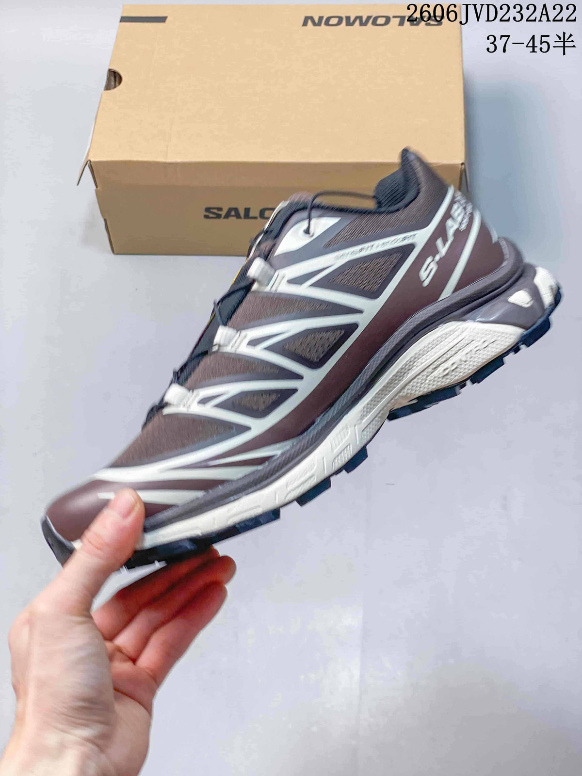 Side view of the brown and gray Salomon XT-6 with light overlays and a lugged outsole.