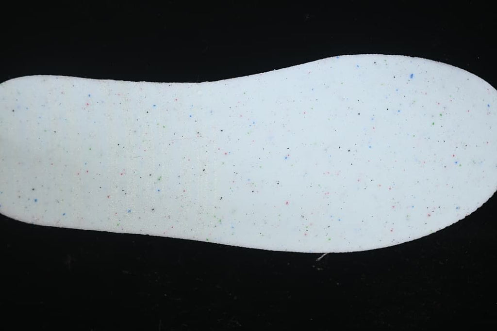 Close-up of a white insole with multicolored speckles