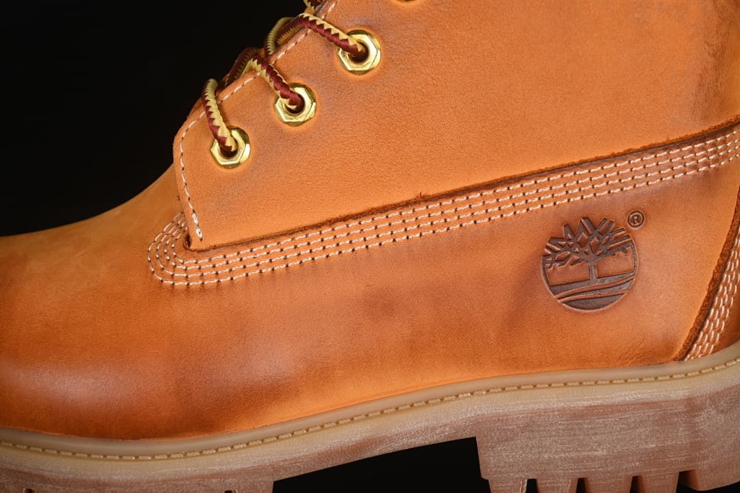 Close-up of side stitching, eyelets, laces, and embossed tree logo