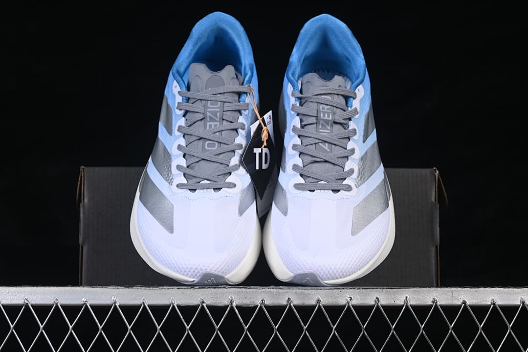 Front view of the pair showing the white toes, gray laces, and silver accents.