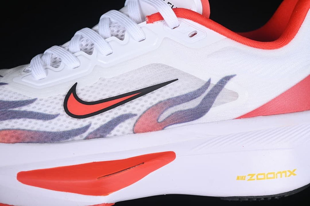 Close-up of the side swoosh, patterned upper, and red midsole accent