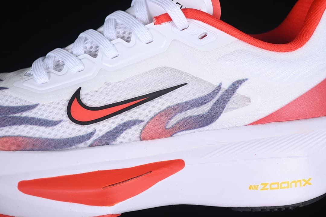 Close-up of the side swoosh, patterned upper, and red midsole accent