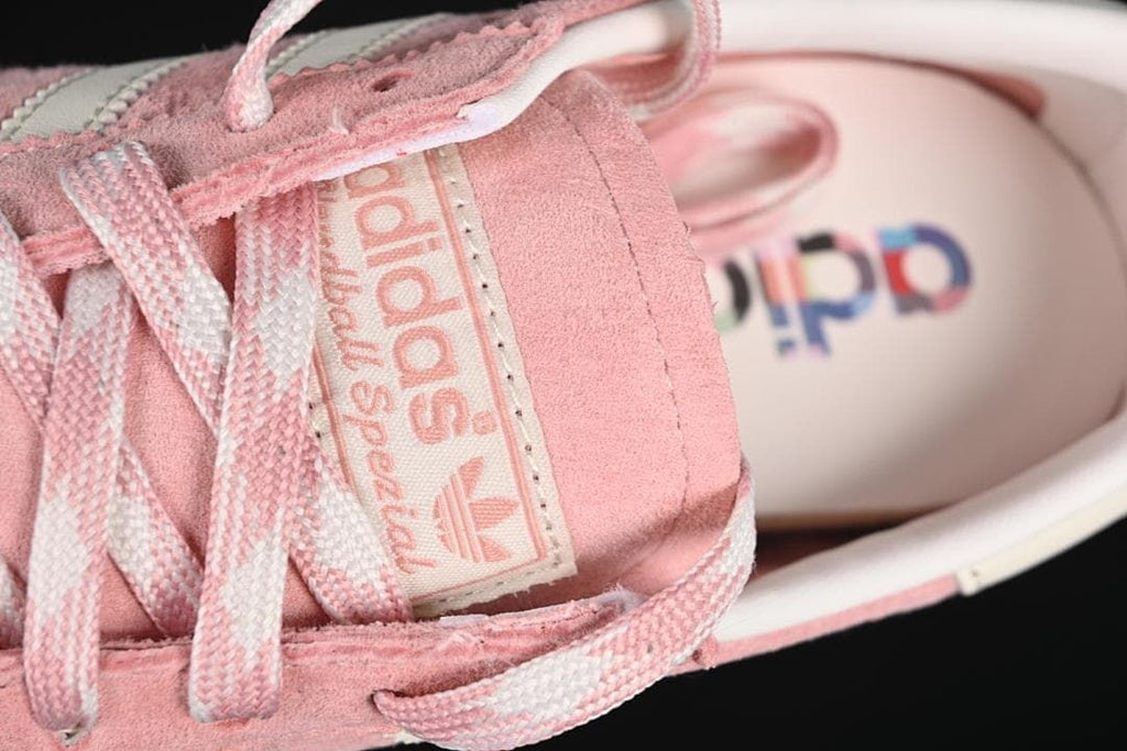 Close-up of the tongue label and pink-and-off-white laces