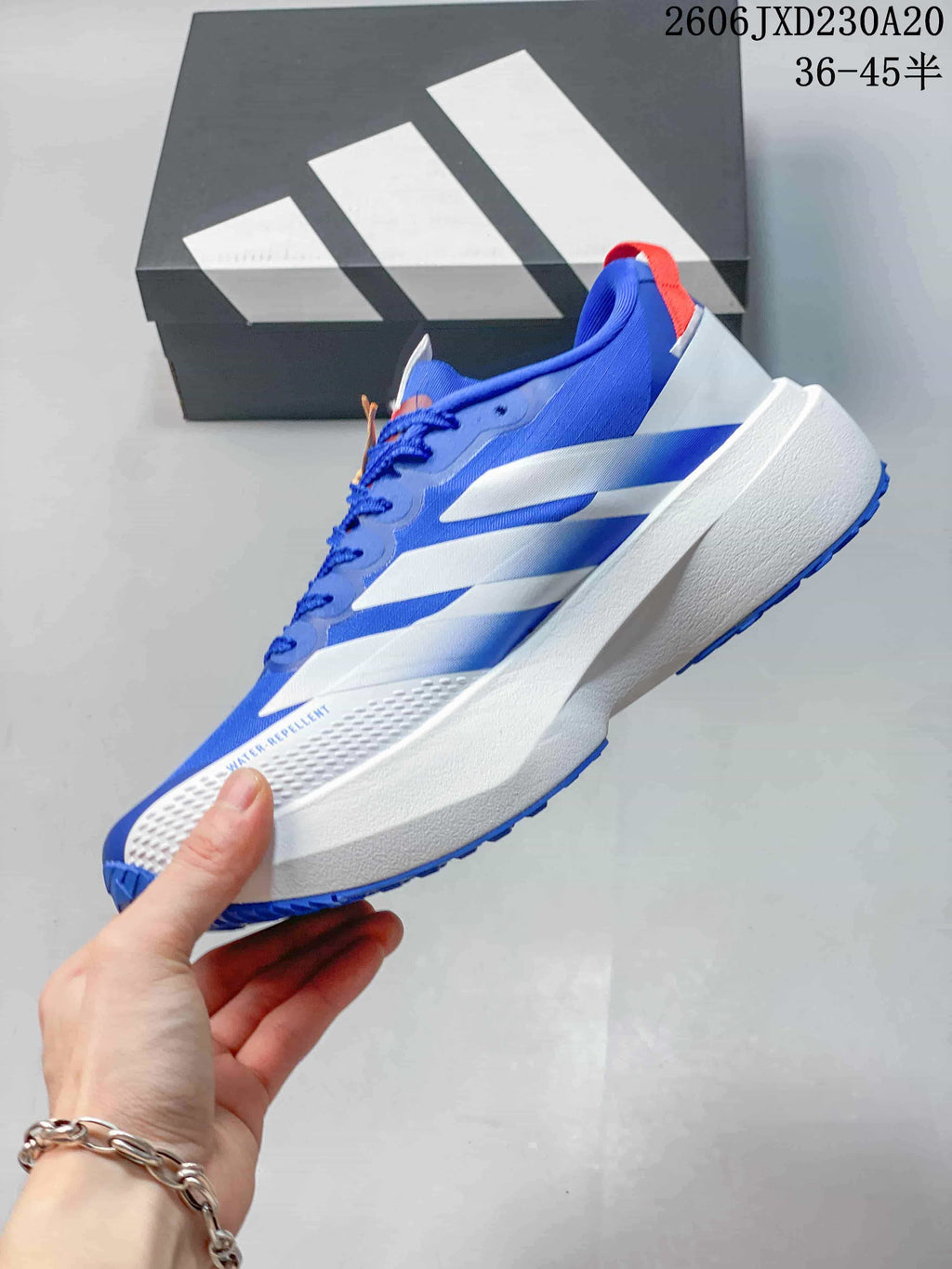 Side view of a blue Adidas Adizero Evo SL running shoe with white stripes and a thick white midsole