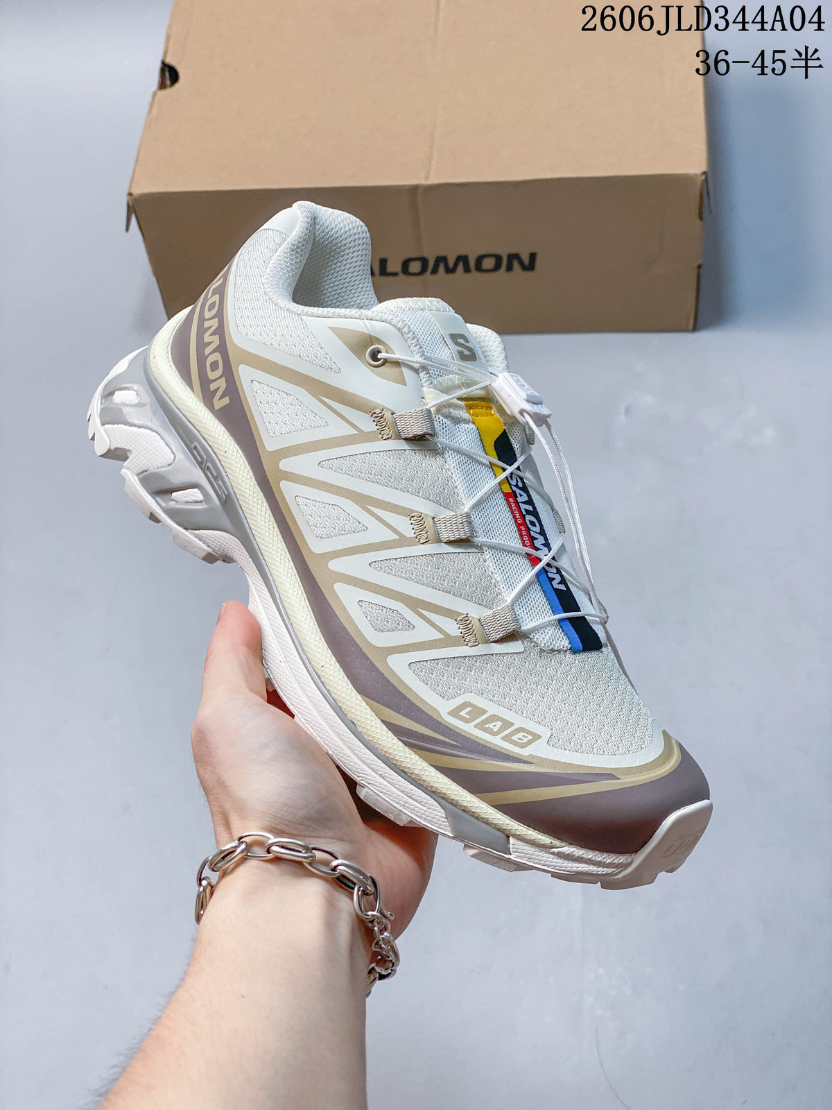 Angled side and top view of the white and taupe Salomon XT-6 shoe.