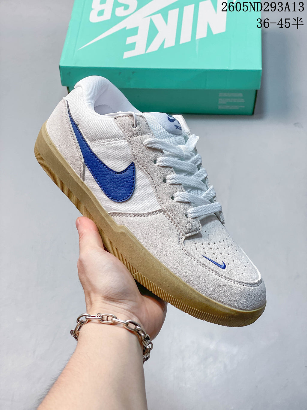 White and light gray Nike SB Force 58 shoe with a blue Swoosh and gum-colored outsole