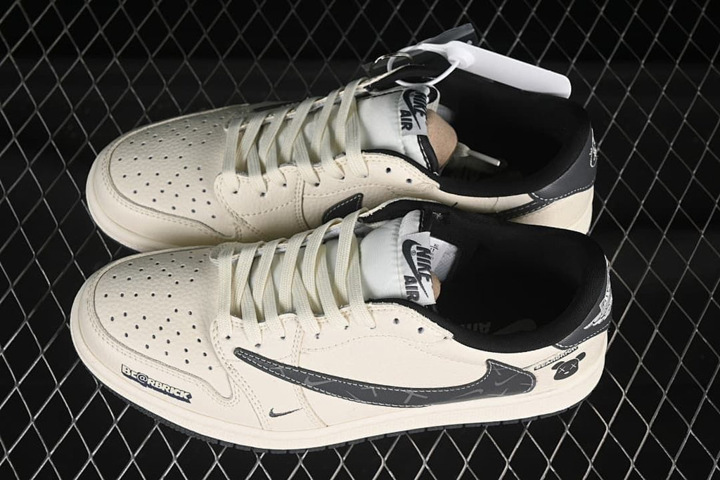 Top view of a pair of off-white and black low-top sneakers showing perforated toes, laces, and dark collars