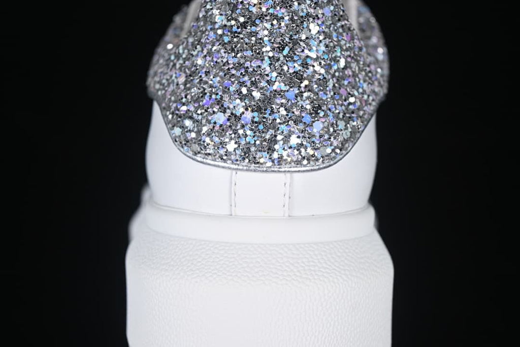 Rear view showing the glitter heel panel and thick white sole.