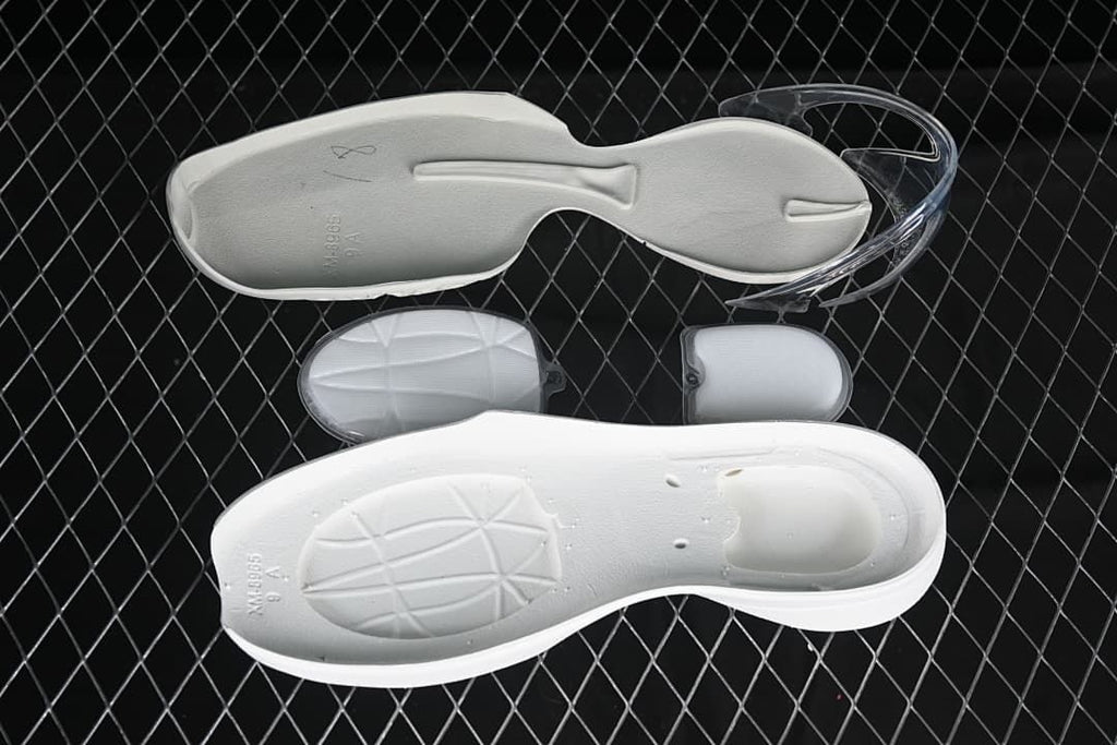 Removable shoe components displayed beside a white insole