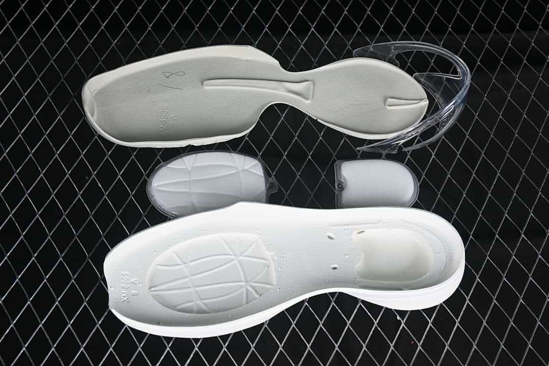 Removable shoe components displayed beside a white insole