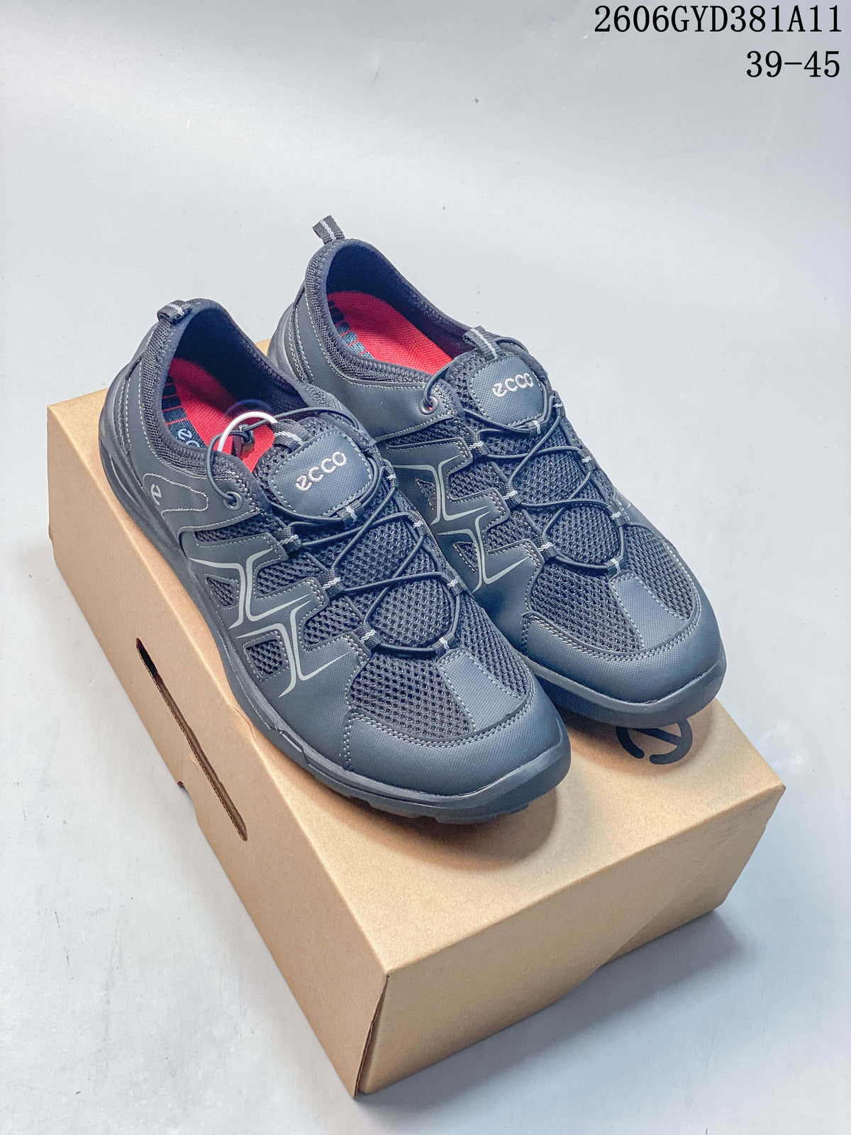 Pair of gray ECCO sneakers with elasticated laces and red interior accents, shown on a box.