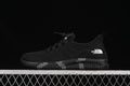 Side view of a black The North Face sneaker with a sculpted sole