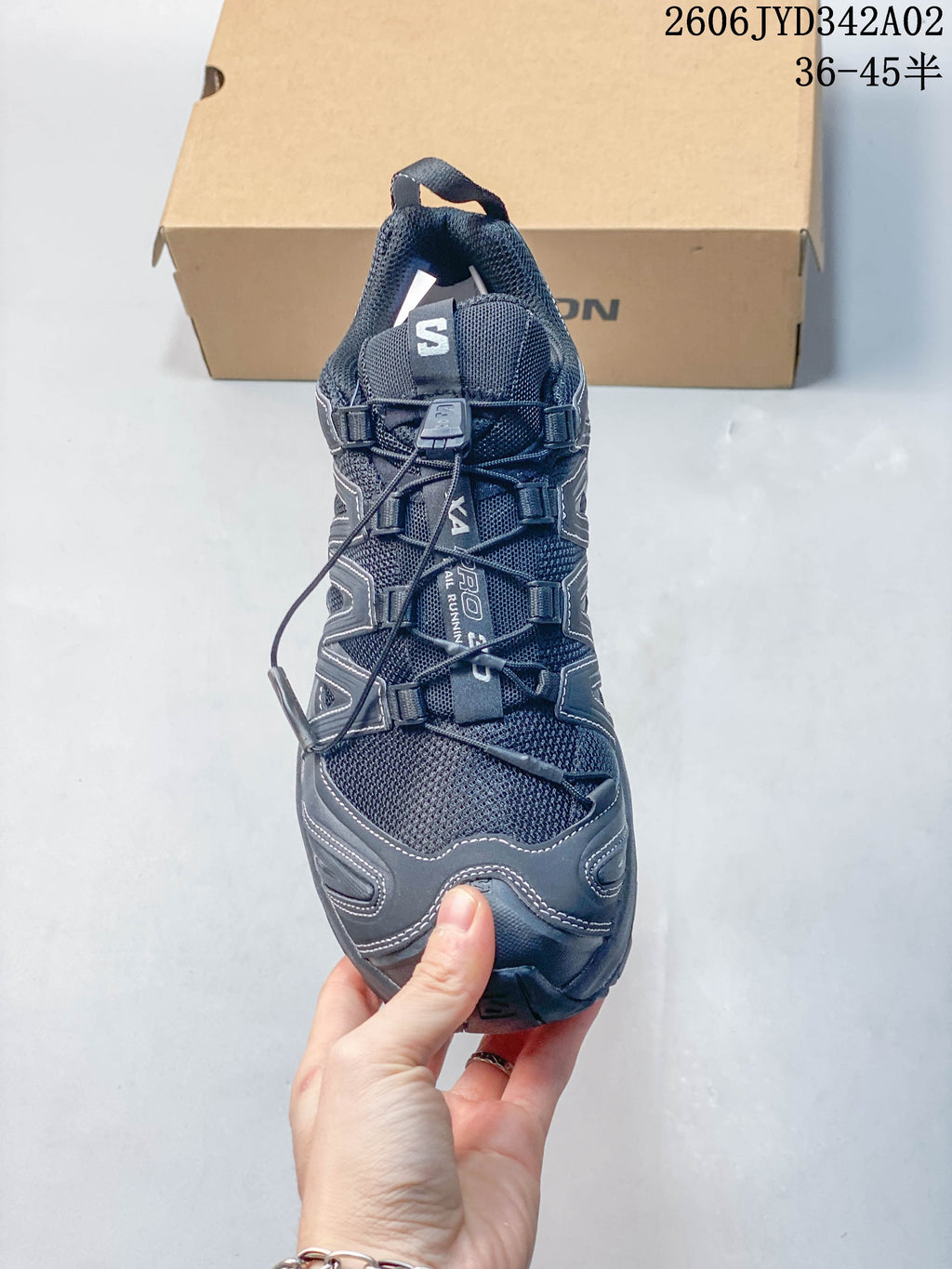 Front view showing the quick-lace closure and upper of a dark gray trail running shoe