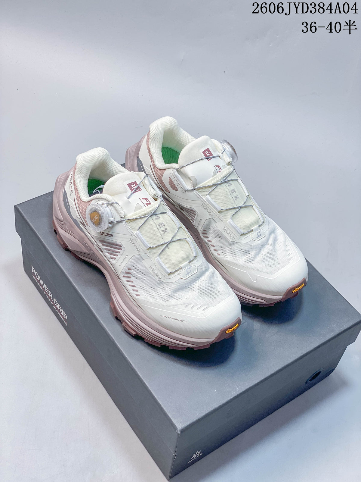 Pair of off-white and muted rose Kailas FUGA EX3 BOA hiking shoes shown on a shoe box