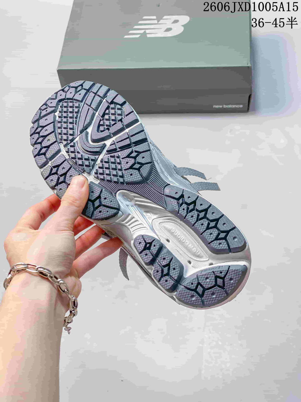 Close-up of the patterned outsole of a silver-grey sneaker