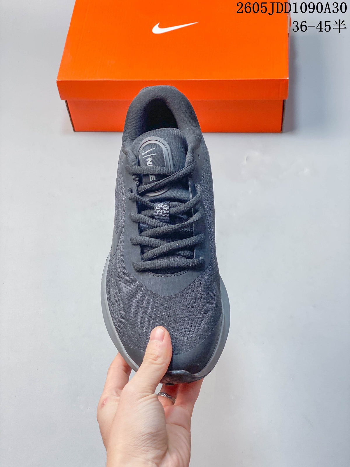 Top view of a dark gray Nike Journey Run shoe showing its laces and textile upper.