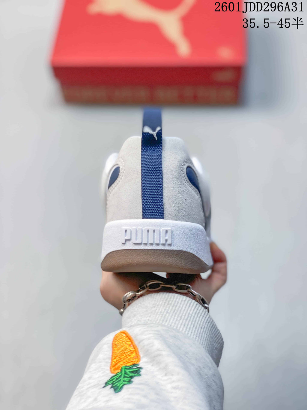 Rear view of a PUMA sneaker with a navy heel pull tab