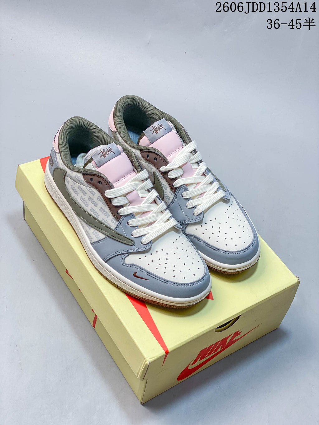Pair of low-top sneakers showing white, blue-gray, olive, pale pink and brown color blocking