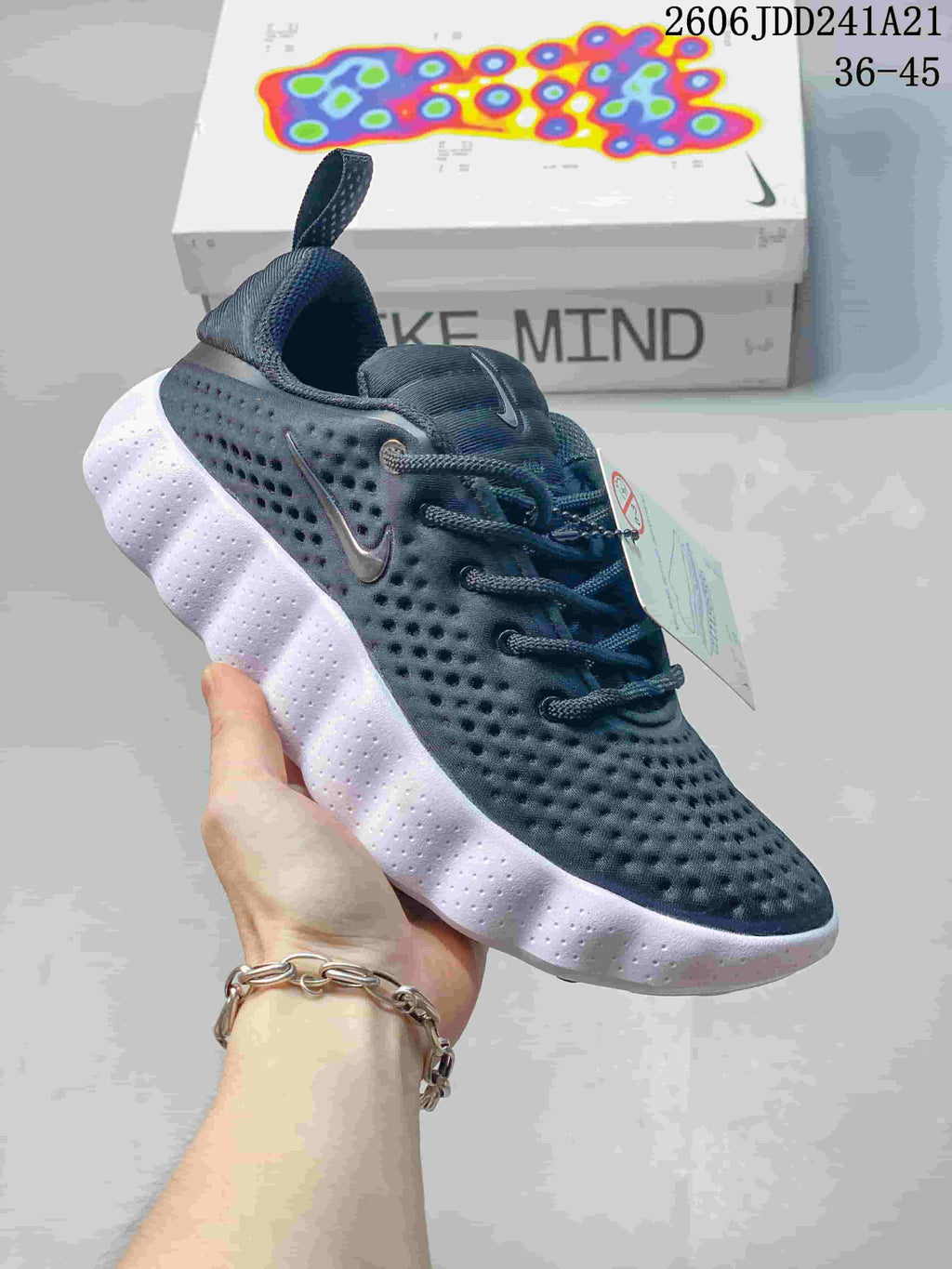 Dark navy Nike Mind 002 SP FK shoe with a dimpled upper and thick white outsole.
