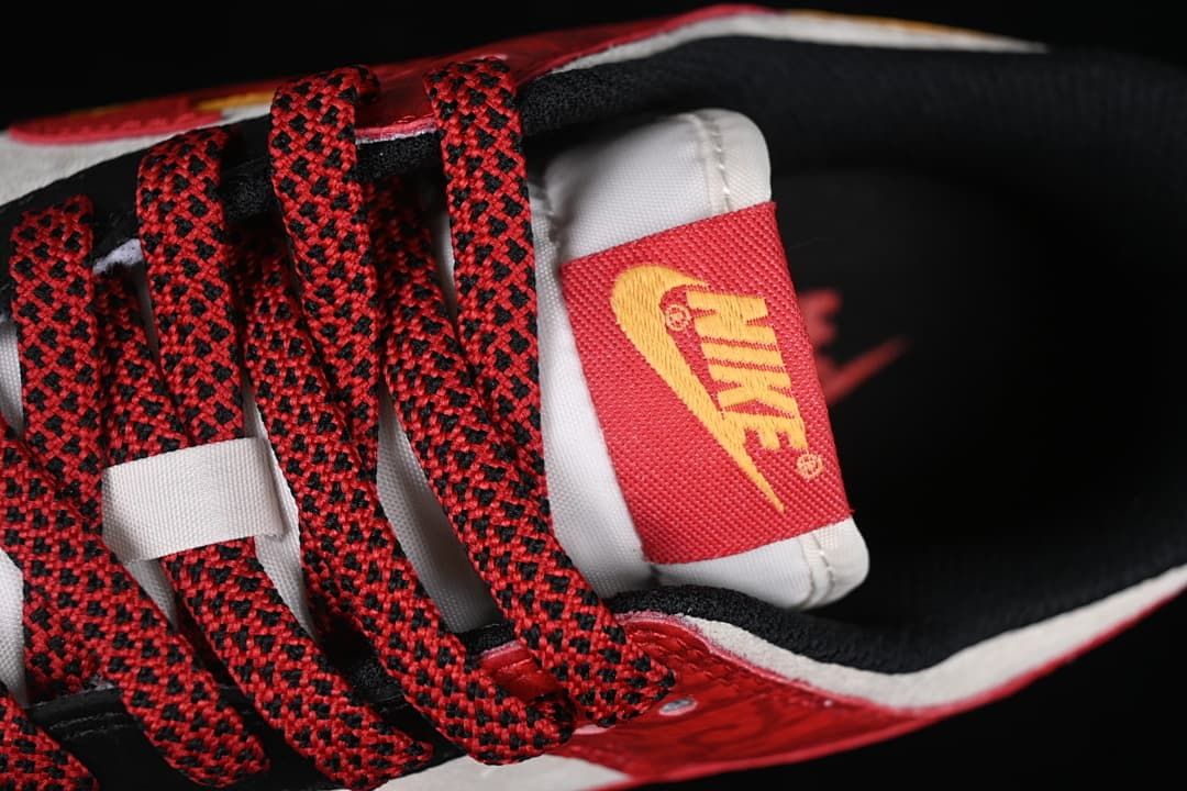 Close-up of red-and-black patterned laces and tongue label