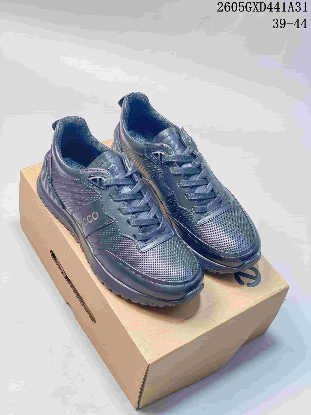 Pair of dark navy ECCO lace-up sneakers displayed on a box