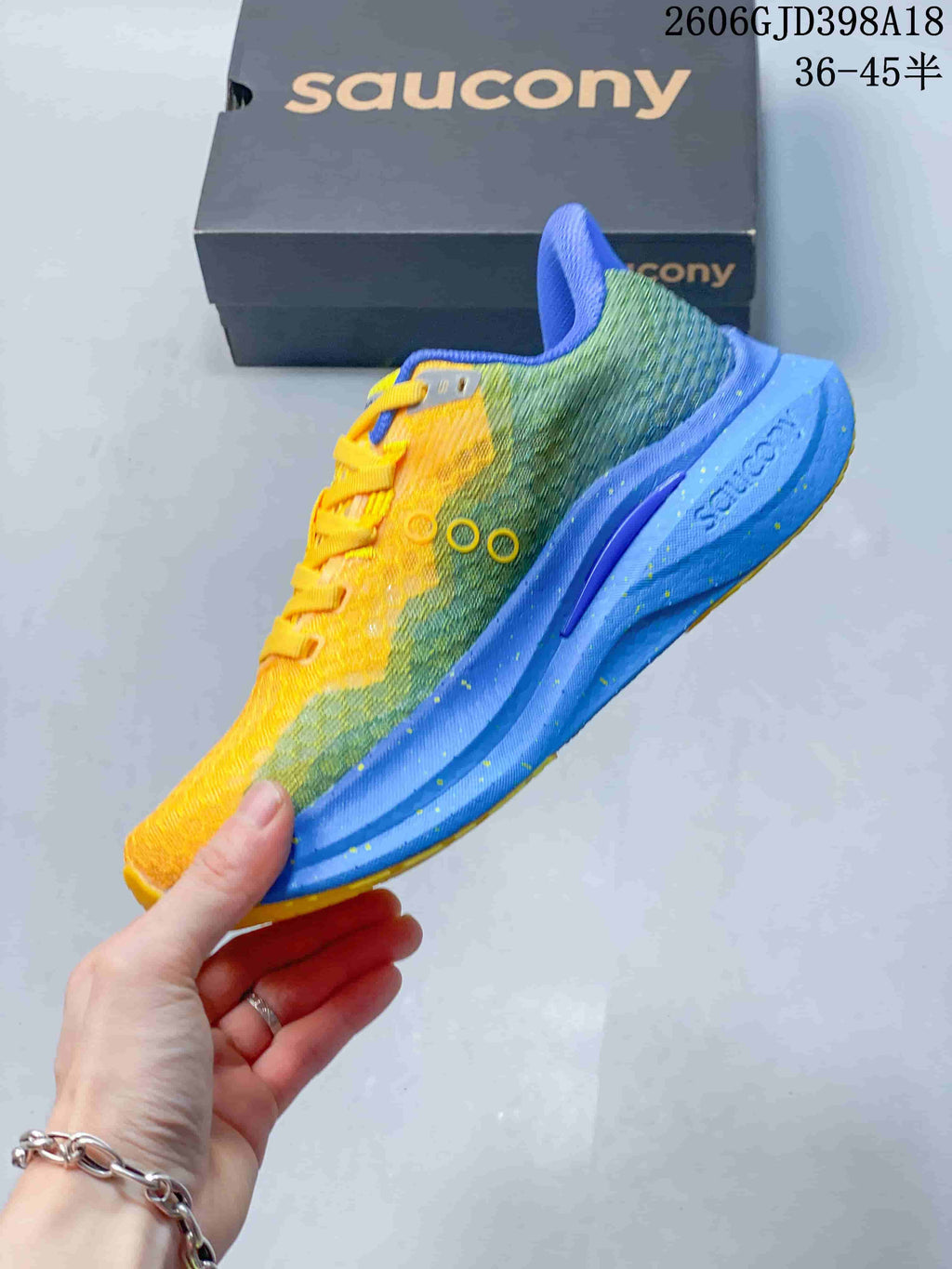 Side view of the yellow and green Saucony running shoe with a blue sole
