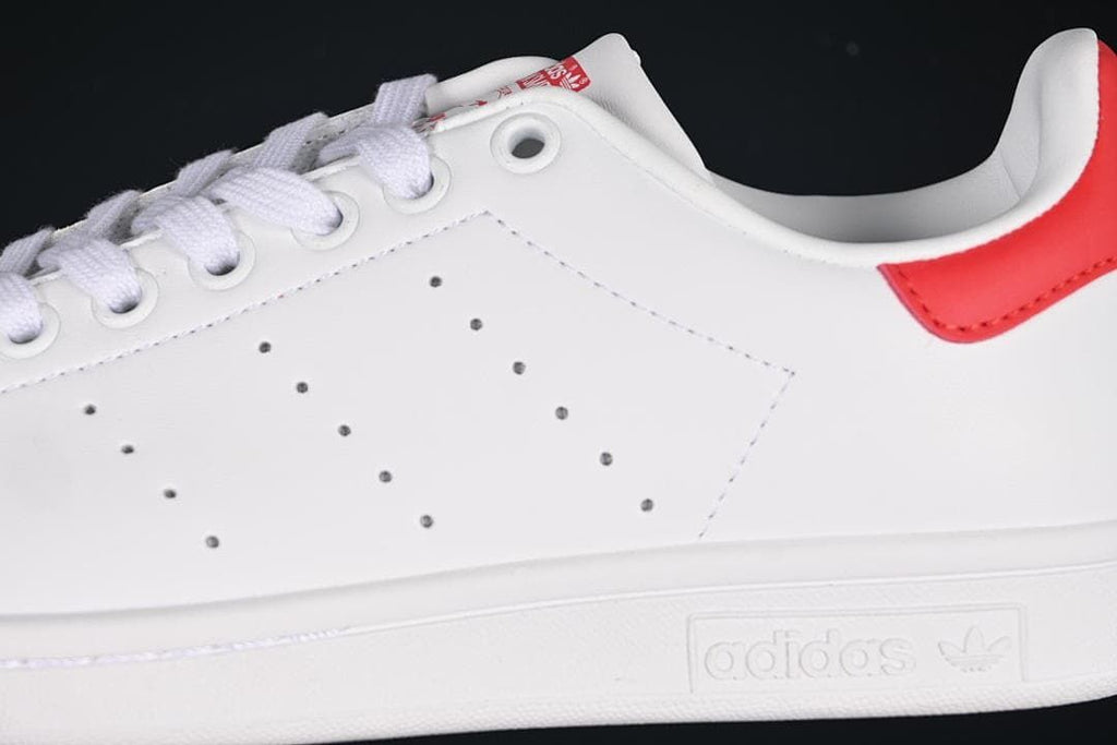 Close-up of perforated side panel, laces and red heel accent