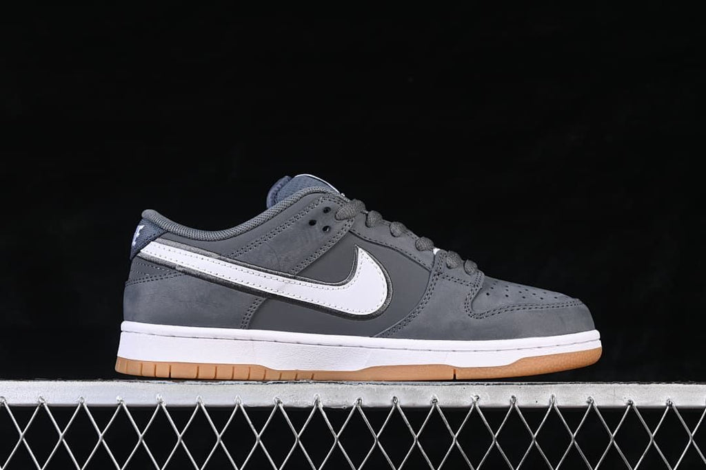 Side profile of the gray sneaker with white side panels and a gum-colored outsole.