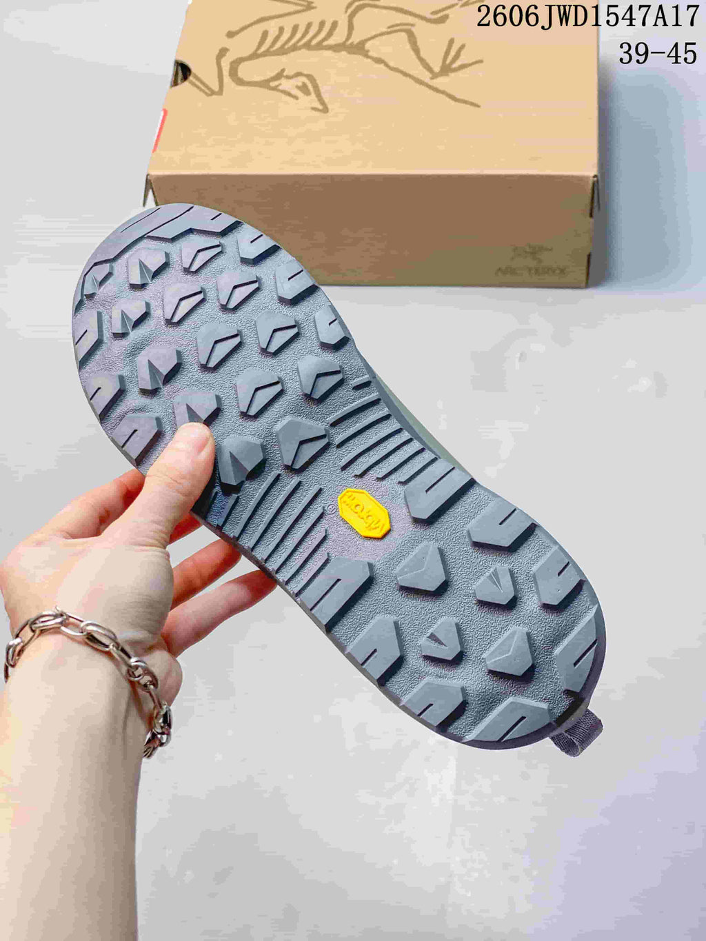 Close-up of the lugged outsole on a grey outdoor shoe