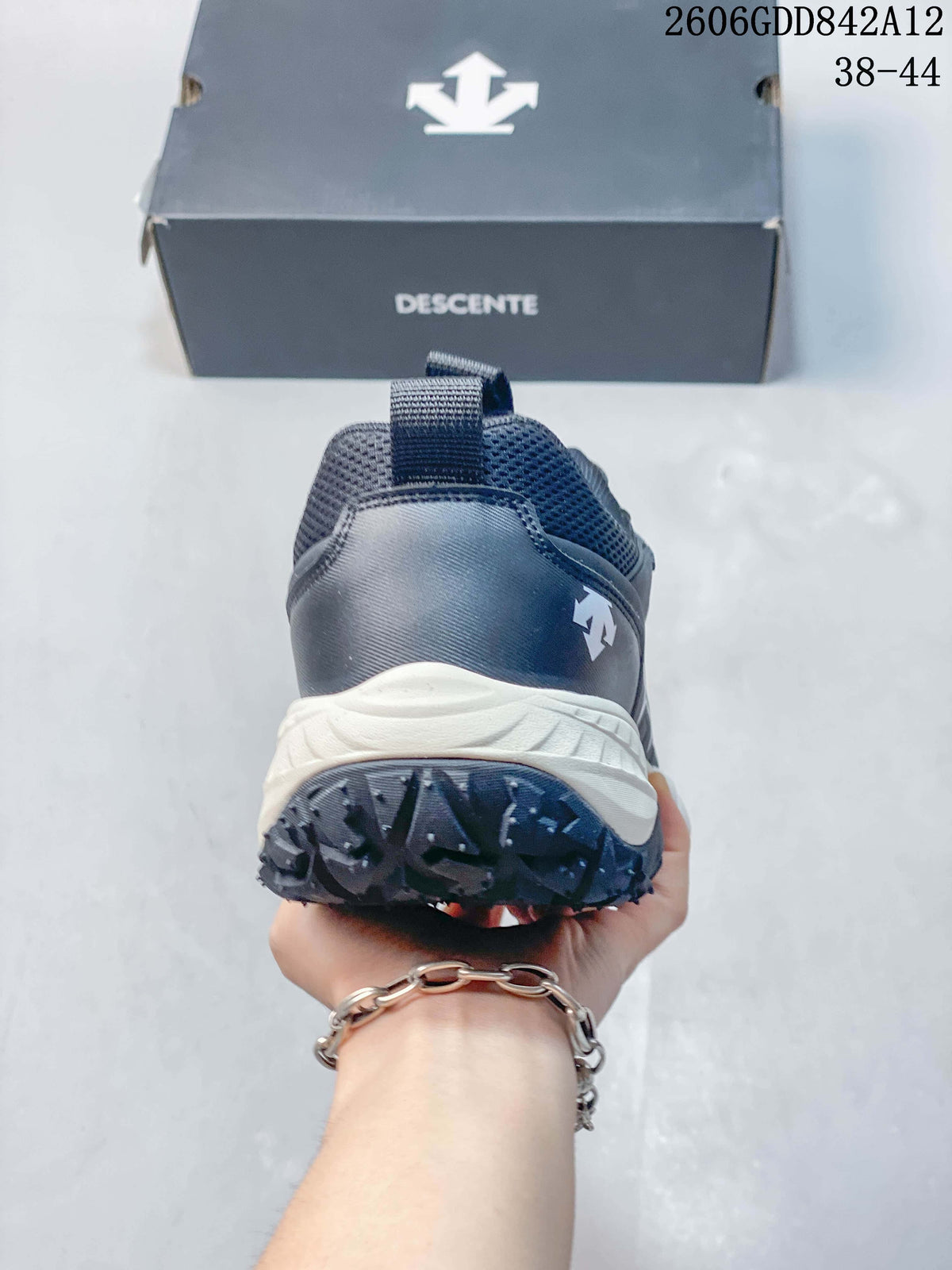 Rear view of a gray DESCENTE sneaker showing the heel, pull tab, and contrasting midsole.
