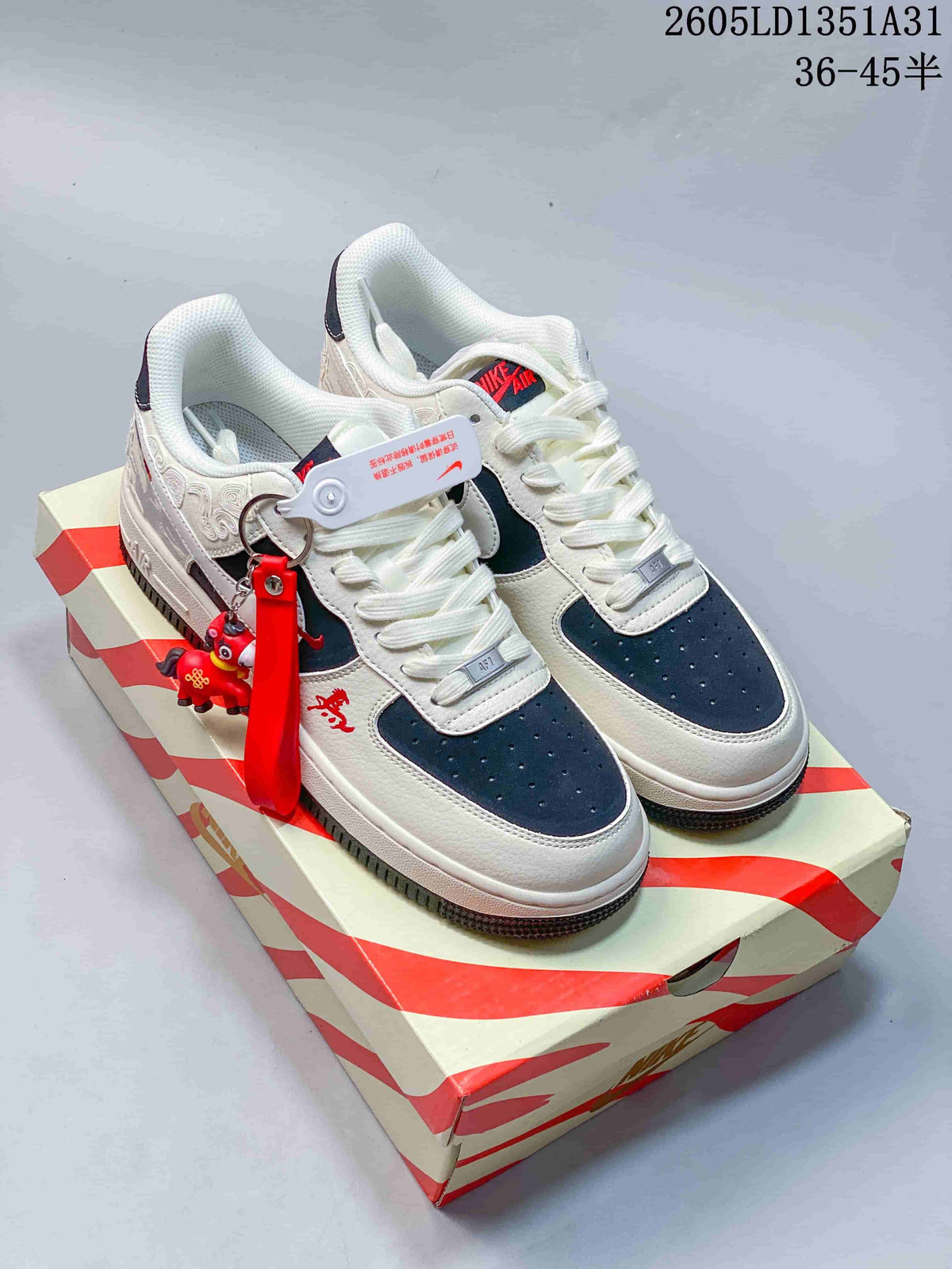 Pair of off-white and navy Air Force 1 sneakers with a horse-themed charm