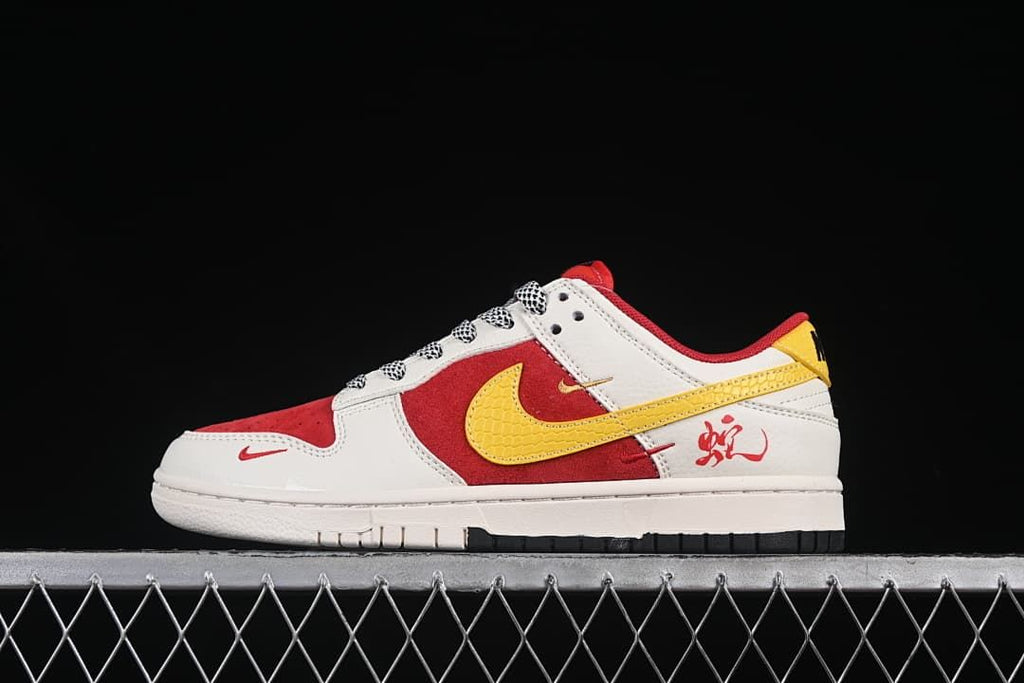 Side view of a red, white, and yellow low-top sneaker with a yellow Swoosh and heel graphic.
