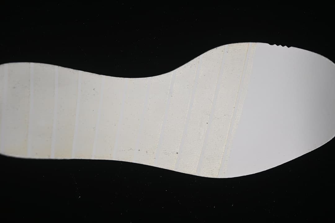 Close view of the light-colored outsole of the running shoe.