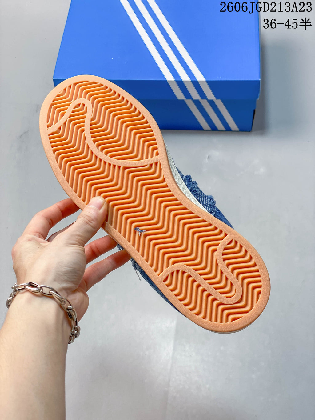 Close-up of the sneaker's gum-colored outsole with a wavy tread pattern.