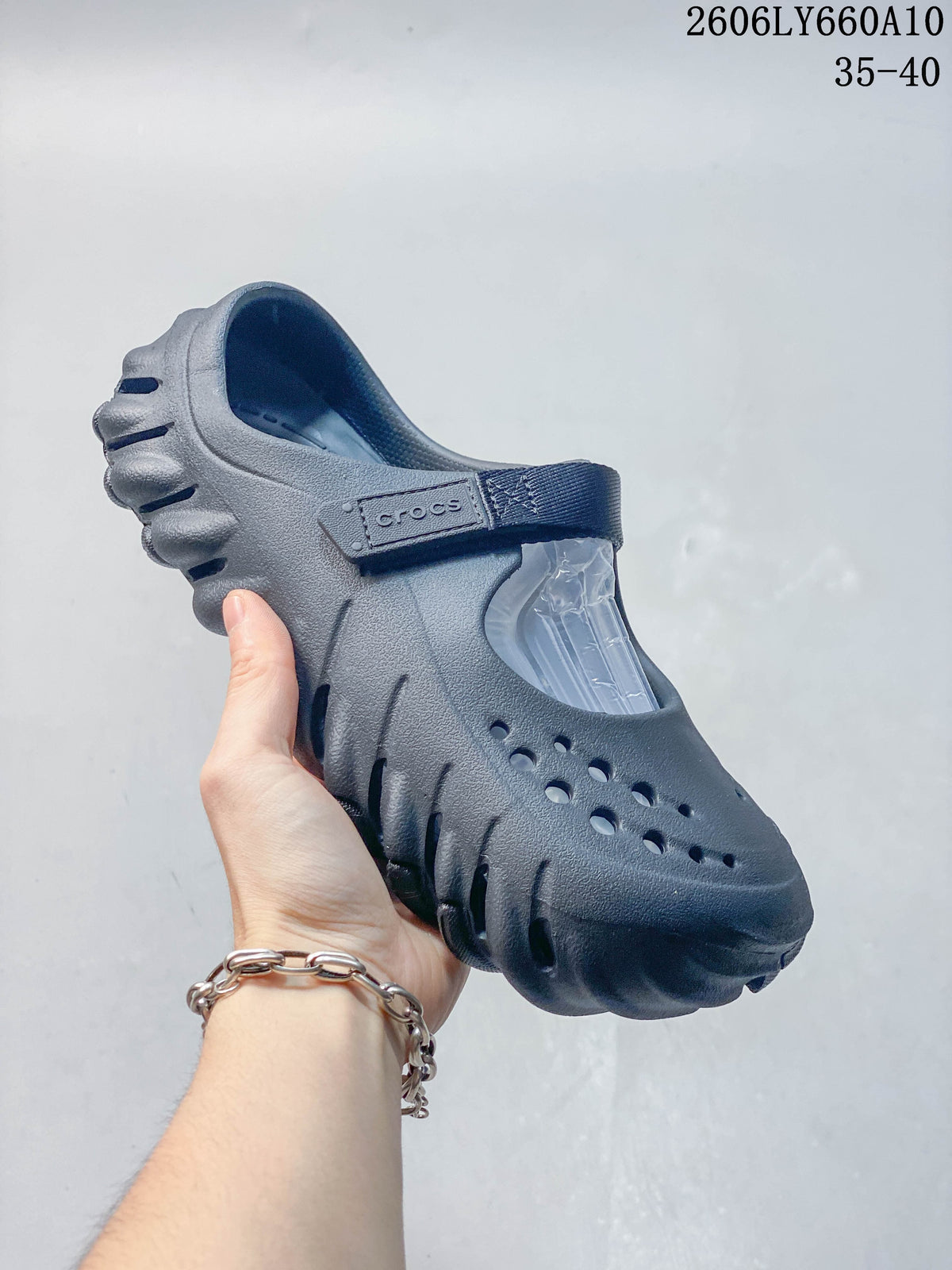 Side view of a dark navy Crocs Mary Jane-style clog showing its perforated upper and sculpted sole.