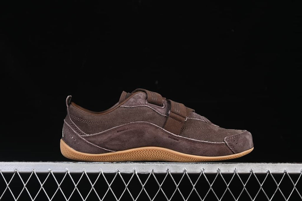 Side profile of the brown sneaker with its gum-colored outsole.