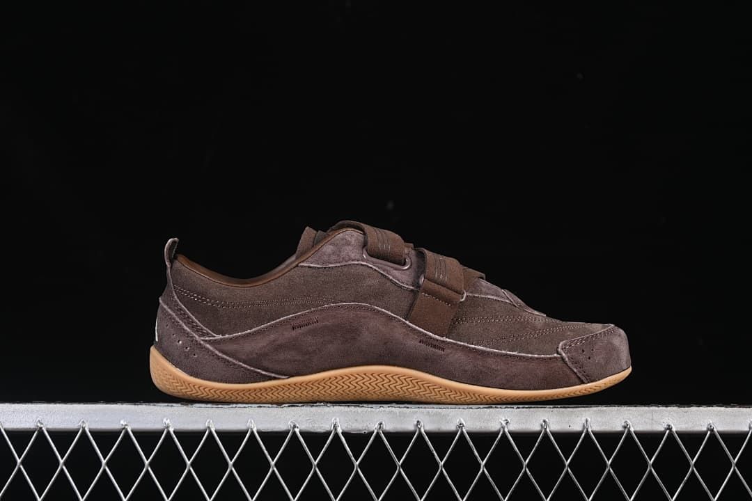 Side profile of the brown sneaker with its gum-colored outsole.