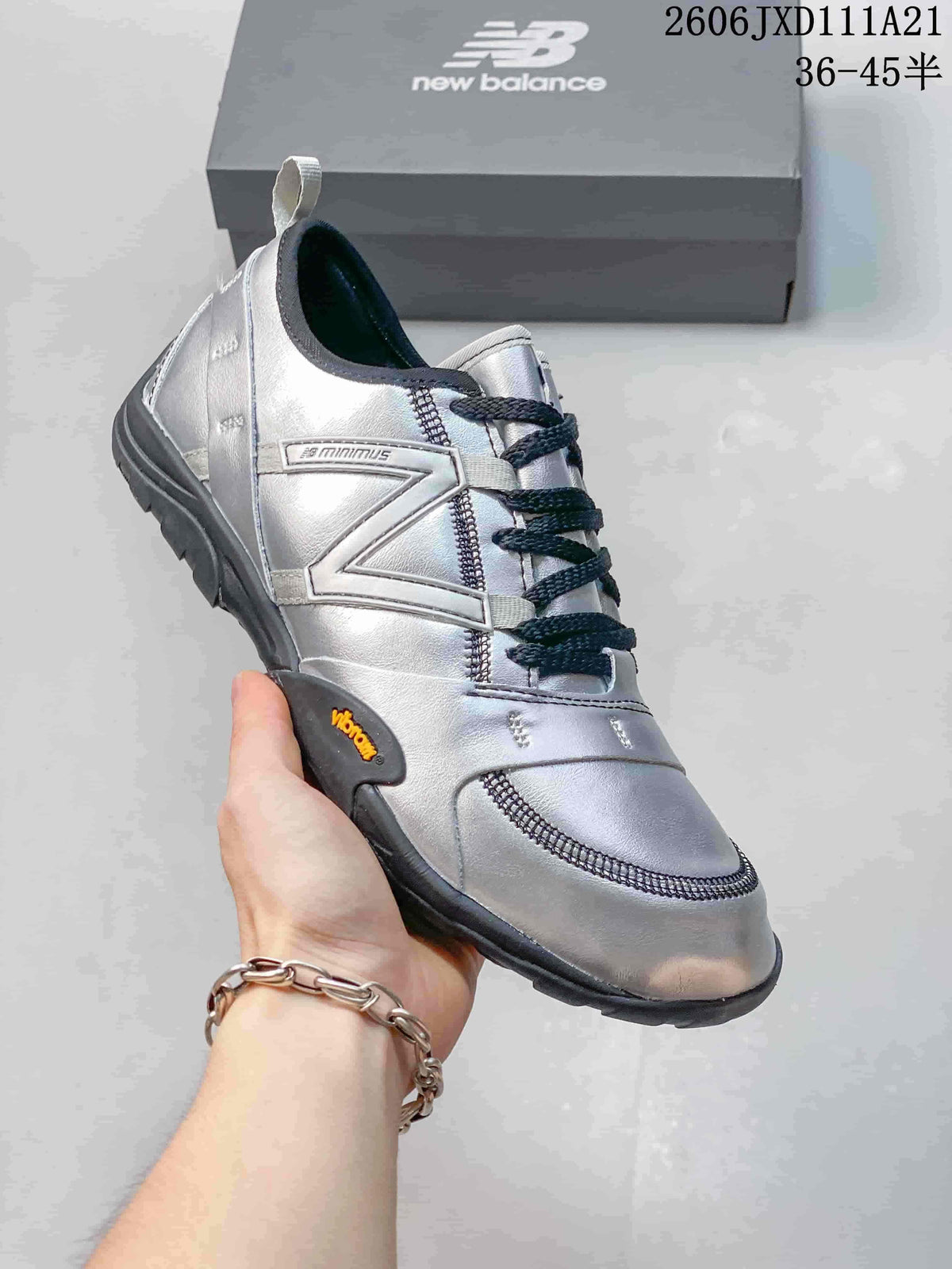 Close side view showing the logo detail, low-profile sole, and silver-toned upper